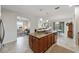 Open-concept kitchen with granite countertops, stainless steel appliances, and a view into the living area at 9704 Sw 95Th Loop, Ocala, FL 34481