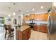 Well-appointed kitchen with ample cabinetry, granite counters, an island with seating, and stainless steel appliances at 9704 Sw 95Th Loop, Ocala, FL 34481