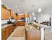 Modern kitchen featuring stainless steel appliances, granite countertops, and wooden cabinetry at 9704 Sw 95Th Loop, Ocala, FL 34481
