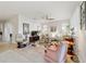 Bright living room with a ceiling fan, comfortable seating, and a view of the backyard at 9704 Sw 95Th Loop, Ocala, FL 34481
