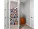 Well-stocked pantry with ample storage, shelving, and an additional storage cabinet at 9704 Sw 95Th Loop, Ocala, FL 34481