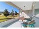 Relaxing screened patio featuring a table, chairs, and a beautiful view of the well-maintained backyard and neighborhood at 9704 Sw 95Th Loop, Ocala, FL 34481
