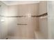 Tiled shower with a mosaic accent stripe, bench, and grab bar at 9704 Sw 95Th Loop, Ocala, FL 34481