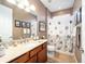 Bathroom featuring tiled floors, vanity, and shower with curtain at 9895 Sw 95Th Loop, Ocala, FL 34481