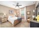 Well-lit bedroom offering carpeted floors, a ceiling fan, and neutral-colored walls at 9895 Sw 95Th Loop, Ocala, FL 34481