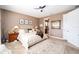 Comfortable bedroom featuring neutral paint, ceiling fan, and ensuite bathroom at 9895 Sw 95Th Loop, Ocala, FL 34481
