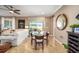 Cozy dining area with a glass table, seamlessly connected to the living space and outdoor views at 9895 Sw 95Th Loop, Ocala, FL 34481