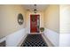 Welcoming entryway showcasing a decorative front door, attractive decor, and patterned rug at 9895 Sw 95Th Loop, Ocala, FL 34481