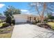 Charming one-story home with a well-manicured front yard and a two car garage at 9895 Sw 95Th Loop, Ocala, FL 34481