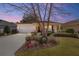 Charming single-story home with a well-manicured lawn and beautiful landscaping at sunset at 9895 Sw 95Th Loop, Ocala, FL 34481