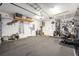 A spacious garage with carpet, storage shelves, and a workbench at 9895 Sw 95Th Loop, Ocala, FL 34481