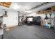 Well-organized garage with carpet, work bench, storage cabinets and ladder at 9895 Sw 95Th Loop, Ocala, FL 34481