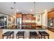 Modern kitchen with granite counters, stainless steel appliances, and a breakfast bar with seating at 9895 Sw 95Th Loop, Ocala, FL 34481