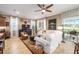 Open-concept living room with views to the outdoors, stylish furniture, and a comfortable seating area at 9895 Sw 95Th Loop, Ocala, FL 34481