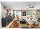 Cozy living room with neutral tones, stylish furnishings, and ample natural light from large windows at 9895 Sw 95Th Loop, Ocala, FL 34481
