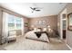 Serene main bedroom with a plush bed, soft lighting, and an en-suite bathroom for added privacy at 9895 Sw 95Th Loop, Ocala, FL 34481