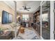 Office room with custom built-in shelves, comfortable seating, and bright natural light at 9895 Sw 95Th Loop, Ocala, FL 34481