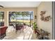 Relaxing screened porch overlooking a lush golf course, perfect for outdoor dining at 9895 Sw 95Th Loop, Ocala, FL 34481