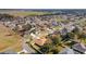 Aerial view of single Gathering homes in a neighborhood with tree lined streets and lush green lawns at 10080 Se 68Th Ct, Belleview, FL 34420