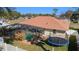 Aerial backyard showcasing a screened-in pool and well-kept lawn surrounded by partial fencing for enhanced privacy at 10080 Se 68Th Ct, Belleview, FL 34420