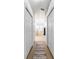 Hallway view of bathroom with tiled flooring, bathtub, glass shower, and natural lighting at 10080 Se 68Th Ct, Belleview, FL 34420