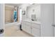 Bathroom featuring white cabinetry, bathtub, and shower combo at 10080 Se 68Th Ct, Belleview, FL 34420