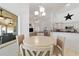 Bright dining area with view of pool area, chandelier lighting and open to the kitchen and living room at 10080 Se 68Th Ct, Belleview, FL 34420