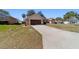 Charming single-story home featuring a well-manicured lawn and an attached two-car garage at 10080 Se 68Th Ct, Belleview, FL 34420