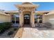 Welcoming front porch with stone accents, a double door entry, and comfortable seating at 10080 Se 68Th Ct, Belleview, FL 34420