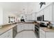 Bright kitchen featuring white cabinetry, stainless steel appliances, and a breakfast bar at 10080 Se 68Th Ct, Belleview, FL 34420