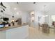 Bright kitchen and dinette area with white cabinetry, stainless steel appliances, and tiled flooring at 10080 Se 68Th Ct, Belleview, FL 34420