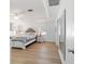 Serene main bedroom featuring a tray ceiling, ceiling fan, and wood-look floors for a comfortable retreat at 10080 Se 68Th Ct, Belleview, FL 34420