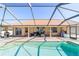 Enclosed swimming pool with an outdoor grill, entertainment area, and enclosed patio seating at 10080 Se 68Th Ct, Belleview, FL 34420