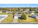 Aerial view of a well-maintained home with a two-car garage, surrounded by mature trees and green lawns at 10255 Se 178Th Pl, Summerfield, FL 34491