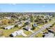 An aerial view of a single-story home nestled in a quiet residential neighborhood with mature trees and well-maintained lawns at 10255 Se 178Th Pl, Summerfield, FL 34491