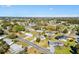 An aerial view showcases a charming single-story home surrounded by lush greenery in a peaceful residential area under a blue sky at 10255 Se 178Th Pl, Summerfield, FL 34491