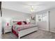 Bedroom featuring a Queen bed with bedside tables, neutral gray walls and plush carpeting at 10255 Se 178Th Pl, Summerfield, FL 34491