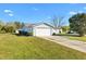 Single-story home with well-manicured lawn, mature trees, a two-car garage, and a lovely curb appeal at 10255 Se 178Th Pl, Summerfield, FL 34491