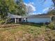 A view of the home's backyard, showing the house siding and back porch with screen enclosure at 10823 Sw 83Rd Ave, Ocala, FL 34481