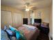 Bedroom featuring wood floors, a ceiling fan and closet at 10823 Sw 83Rd Ave, Ocala, FL 34481