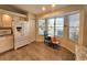 Sunlit kitchen nook with tile flooring, updated white appliances, and a breakfast table near a large window at 10823 Sw 83Rd Ave, Ocala, FL 34481