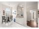 Cozy dining area with a round table, tile floors, and arched entryways to the entryway and bathroom at 11221 Sw 71St Ct, Ocala, FL 34476