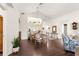 Bright dining room features an elegant chandelier, open bar to the kitchen, and stylish hardwood floors at 11221 Sw 71St Ct, Ocala, FL 34476