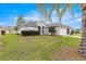 Charming single story home featuring a manicured lawn and landscape and an attached two-car garage at 11221 Sw 71St Ct, Ocala, FL 34476