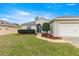 Charming single story home featuring a manicured lawn and landscape and an attached two-car garage at 11221 Sw 71St Ct, Ocala, FL 34476