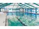 Indoor pool area featuring clear water, lane markers, and ample natural light at 11221 Sw 71St Ct, Ocala, FL 34476