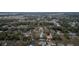 A high aerial view of a residential community with tree lined streets and scattered single Gathering homes at 12164 Se 85Th Ct, Belleview, FL 34420