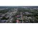 A high aerial view of a residential community with tree lined streets and scattered single Gathering homes at 12164 Se 85Th Ct, Belleview, FL 34420