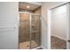 Modern bathroom featuring a glass door shower and a glimpse into a walk-in closet at 12164 Se 85Th Ct, Belleview, FL 34420