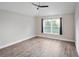 Spacious bedroom with wood flooring and a bright window, creating a serene atmosphere at 12164 Se 85Th Ct, Belleview, FL 34420